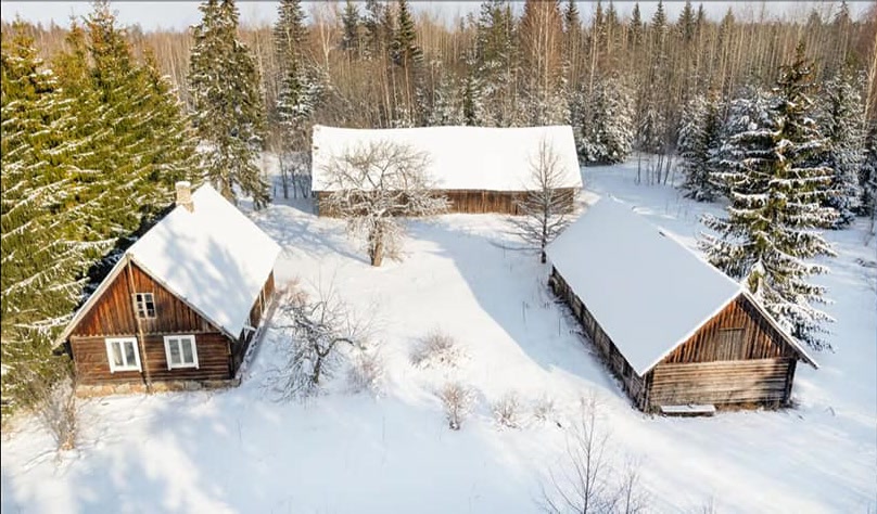 The Allika farm buildings in a winter forest in Oandu